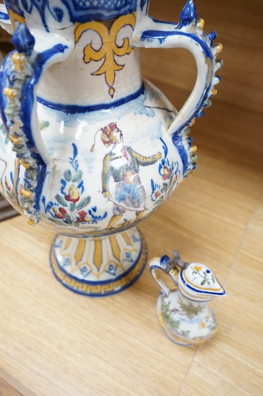 A 19th century faience lidded vase and a later small jug, tallest 49cm. Condition - poor to fair